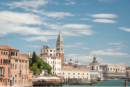 Venitian Gothic buildings including bell tower under blue sky