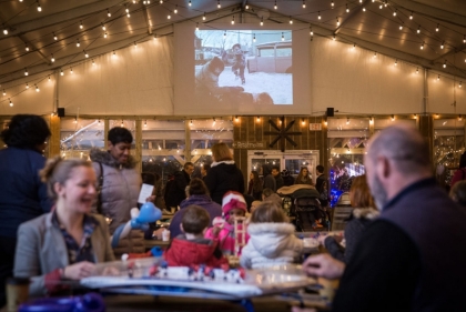 Winterfest crowd having fun in heated tent space.