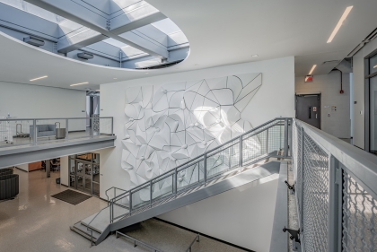 The interior of the library showing its staircase with a dramatic wall relief