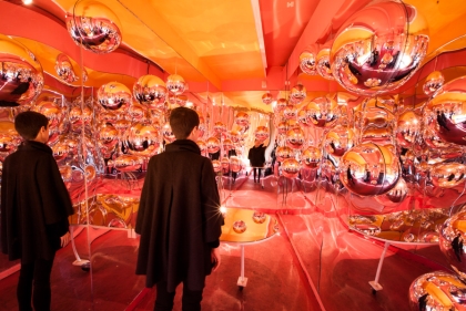 Room installation featuring mirrored walls and mirrored balls