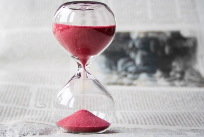 Hourglass with red sand running through it