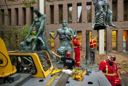 Crew working on sculptures on campus