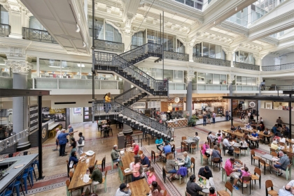 Grand interior space of an old building with elaborate metal staircase