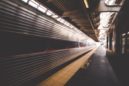Subway train speeding through underground station
