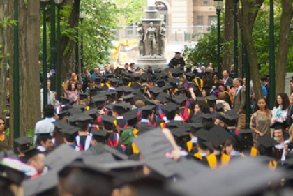 View from behind of crown of students in graduation attire 
