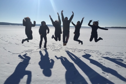 Group in Desert Jumping Up in Air