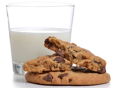Chocolate chip cookies in front of glass of milk