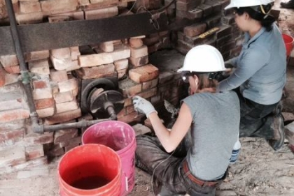 Casey Weisdock (left) and Jean Jang (right) have been putting in many hours with trowel in hand in the effort to stop deterioration at Kilns 7 and 8.