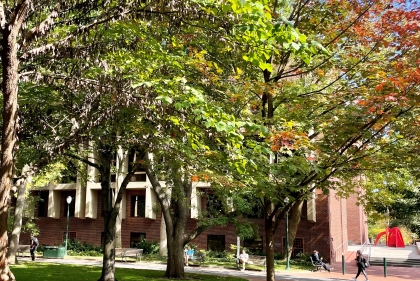 Meyerson seen through the trees of campus