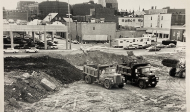 Black and white photo of demolished area and bulldozers