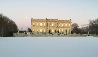 Mansion surrounded by snow covered grounds