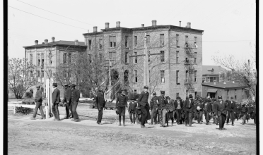 Black and white photo of a 4 story brick building