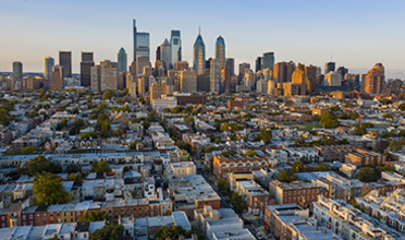 Aerial photo showing the street grid of Philadelphia with skyline in the distance