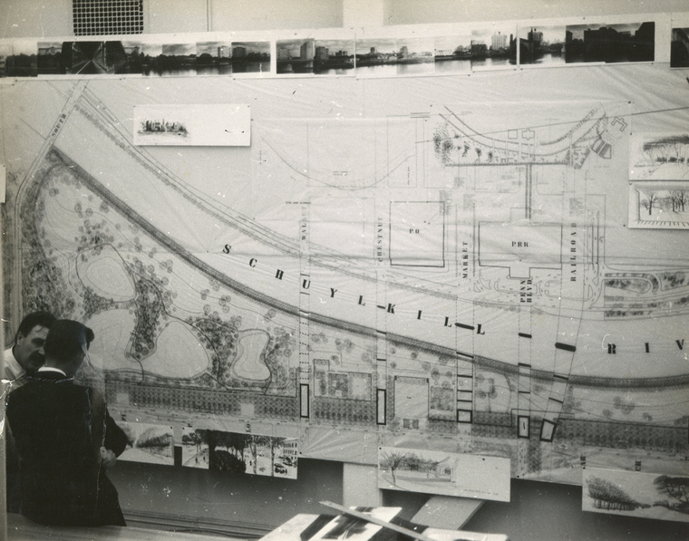 B/W photo of men standing next to blueprints of an area next to the Schuylkill