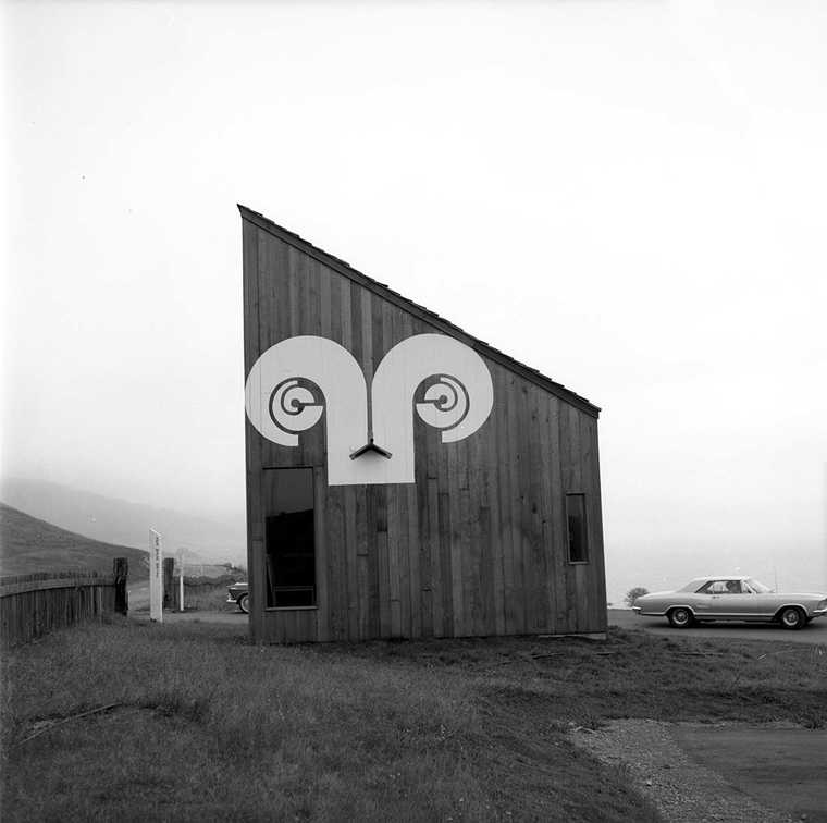 Side of wooden building with design on it similar the Aries astrological sign