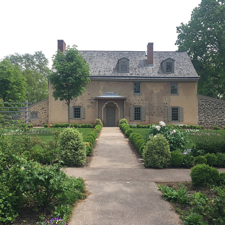 View of a historic home with gardens