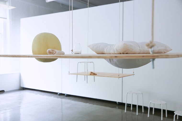 Artist installation with hanging wood and fabric elements