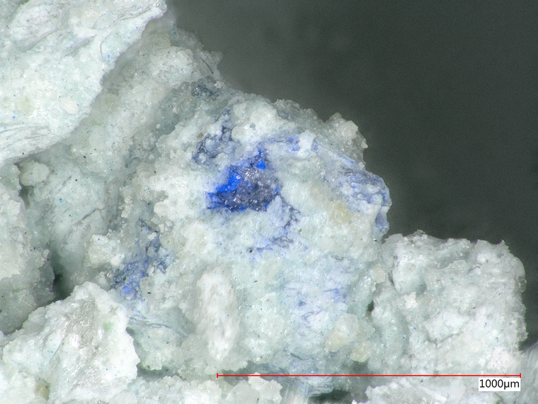 Photomicrograph of an unhydrated blue pigment grain trapped in a Portland cement groundmass. Photo courtesy of Center for the An