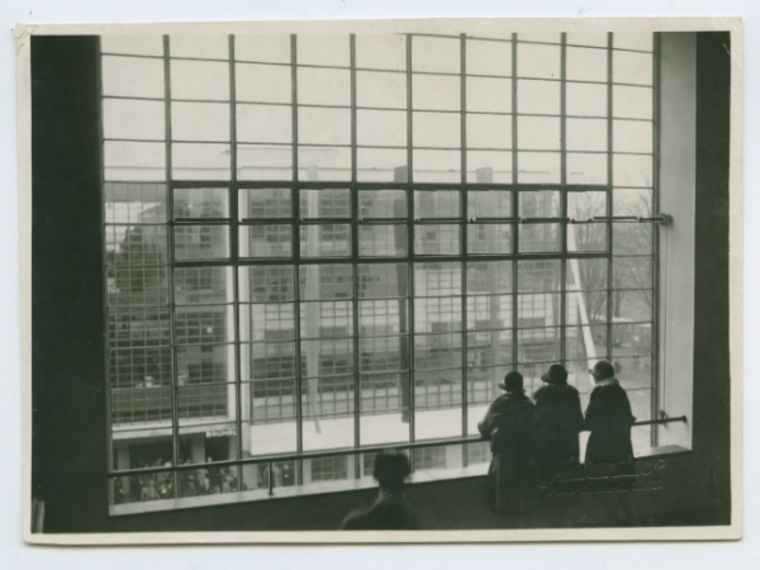 Students looking towards the glass curtain wall from the North Wing of the Bauhaus Dessau