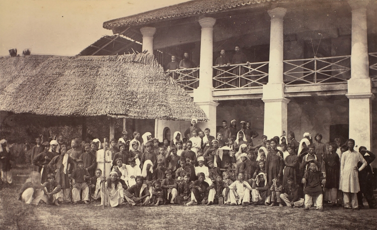 Christian mission in Penang showing the coexistence of different construction systems: a thatch roof and a permanent structure with a colonnade, veranda and tile-roof.