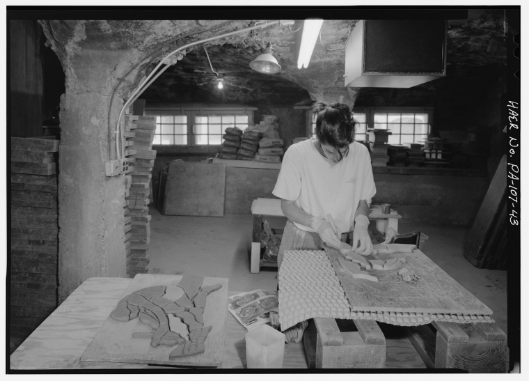 An apprentice making a tile mosaic inside MPTW, 1989.