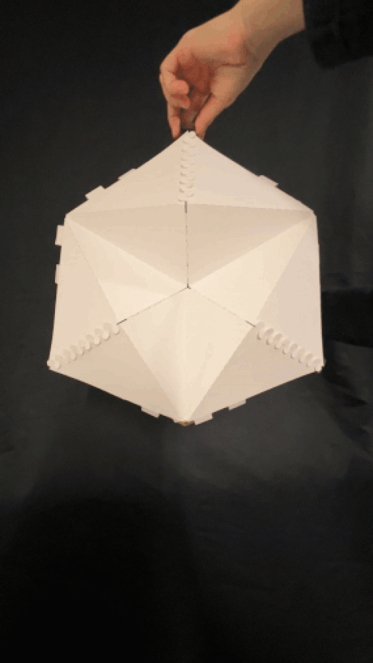 Early study model exploring a kinematic mechanism inspired by the Hoberman sphere — here reconfigured as a tetrahedral geometry with cladding panels. The geometry enables controlled expansion and contraction, forming the basis of the theater’s transformation