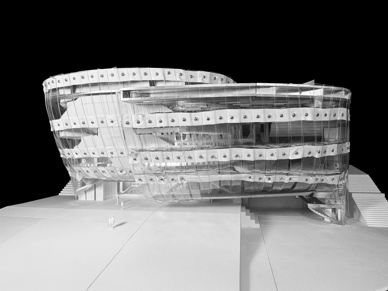 Photograph of a conceptual model exploring the weaving of two material systems within a modular framework. The continuity of structure and surface—spanning façade, slabs, and roof—is achieved through a consistent logic of layered weaving.