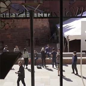 Looking through windows on front of Meyerson at students on the plaza