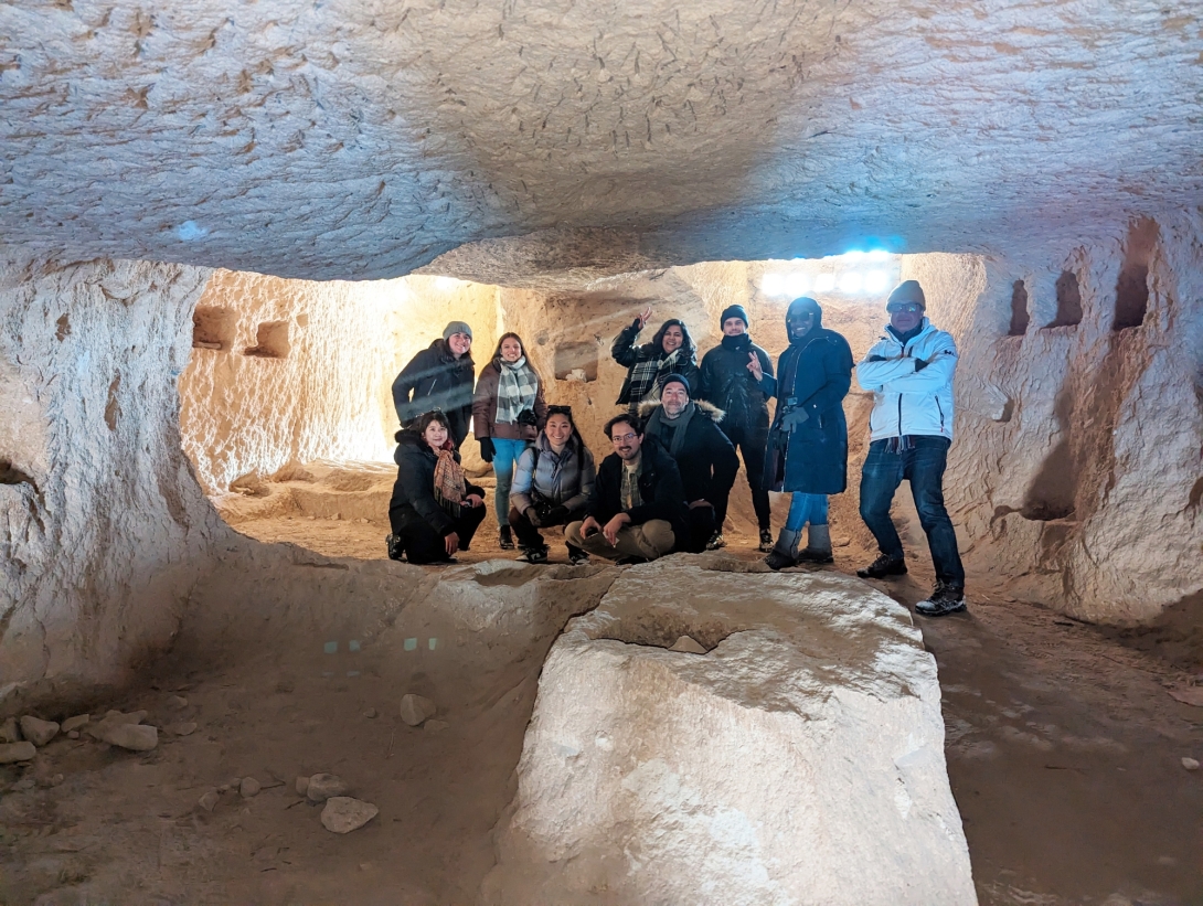 Group of young people in white cavelike enclosure