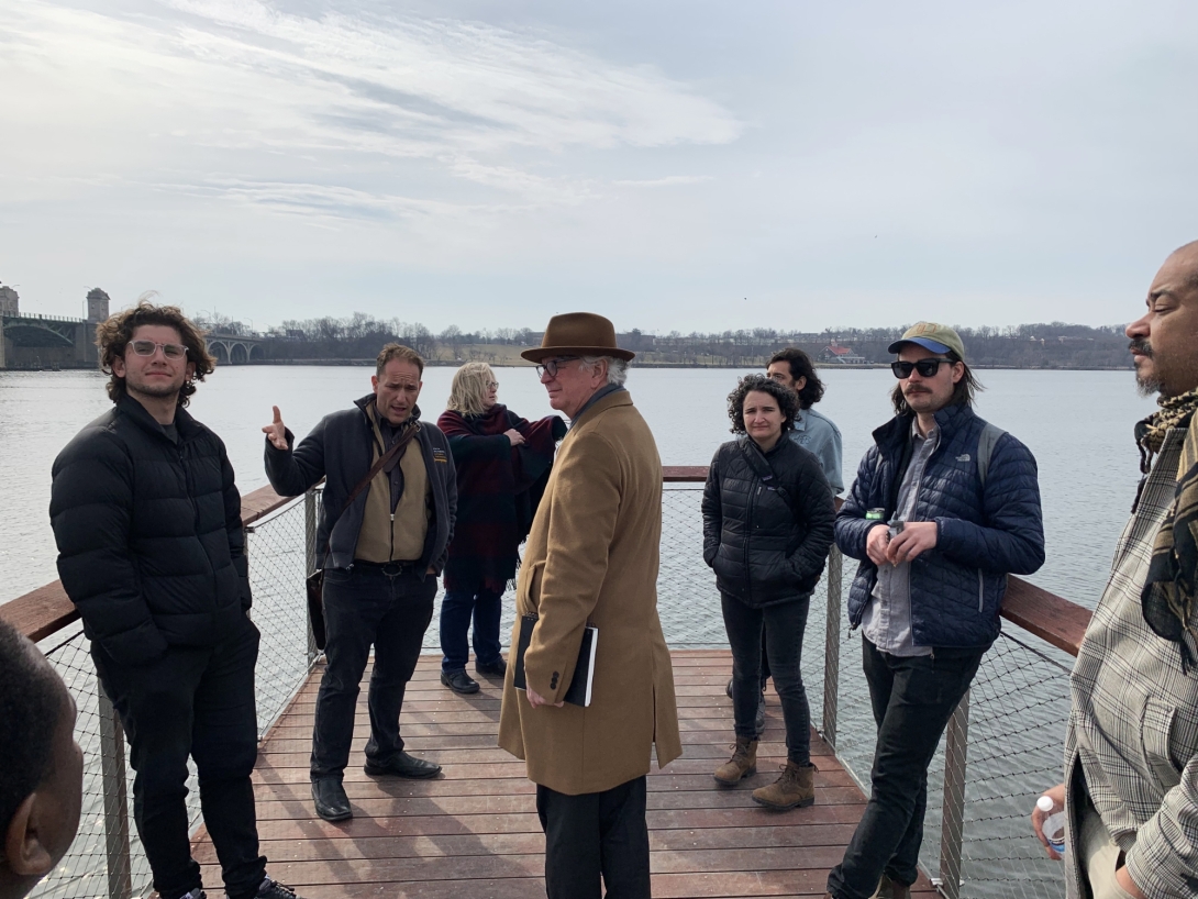 Group of people standing on a pier under blue sky 