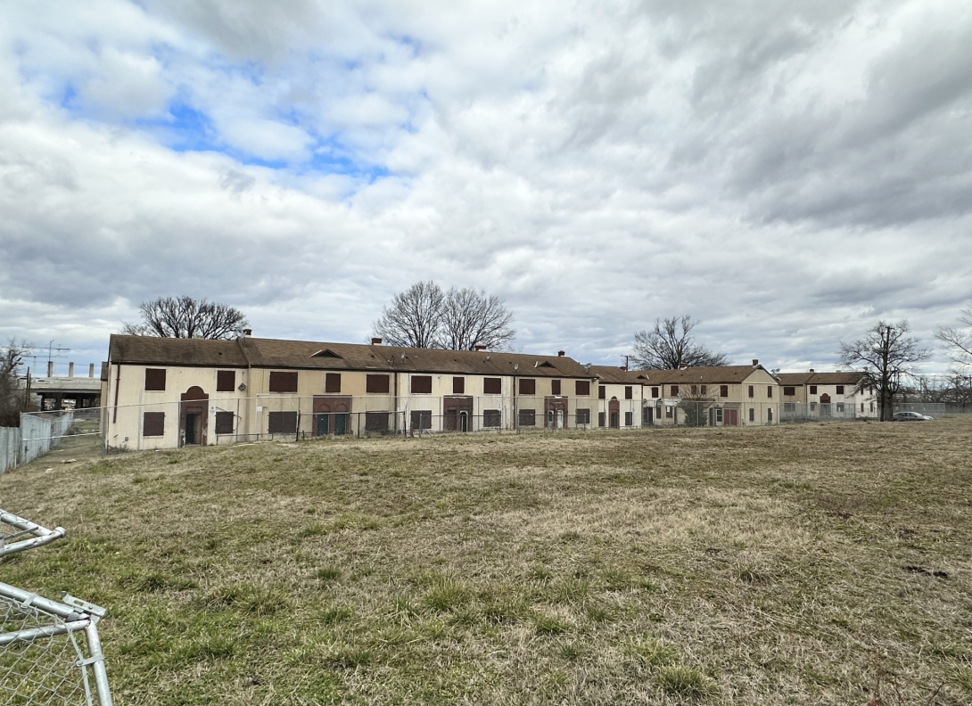 A view of Barry Farm Dwellings seen behind a fence