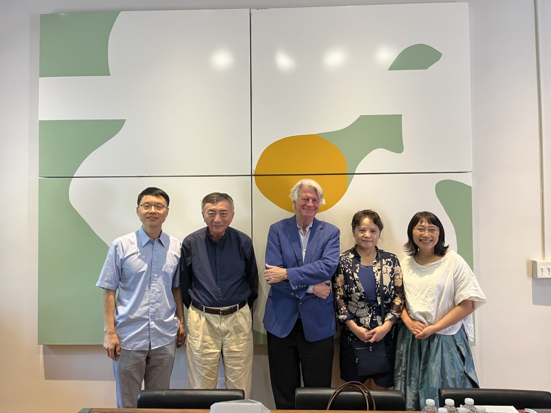 Group of Asian and American people in front of colorful wall panels