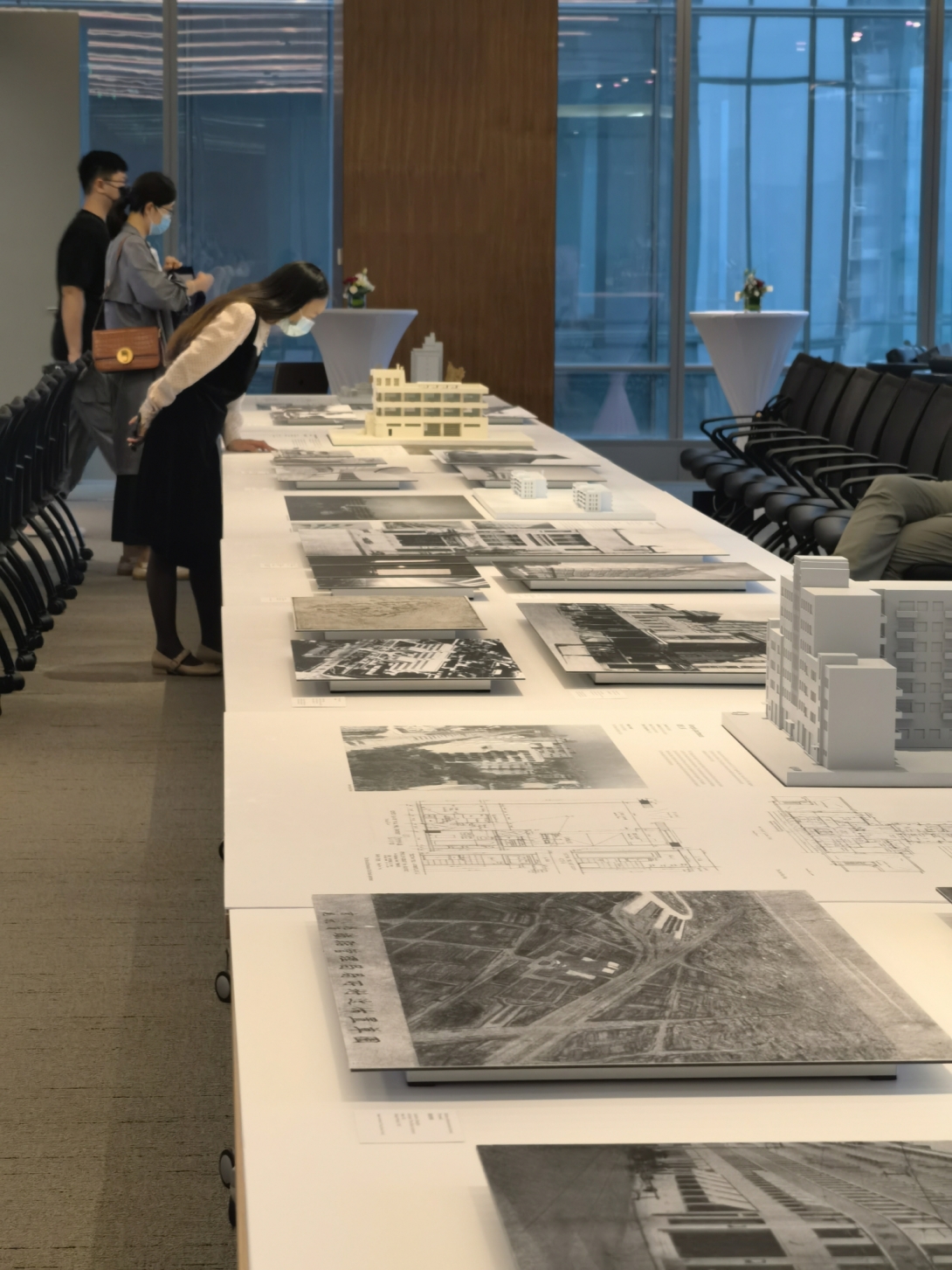 People browse at table with black and white prints