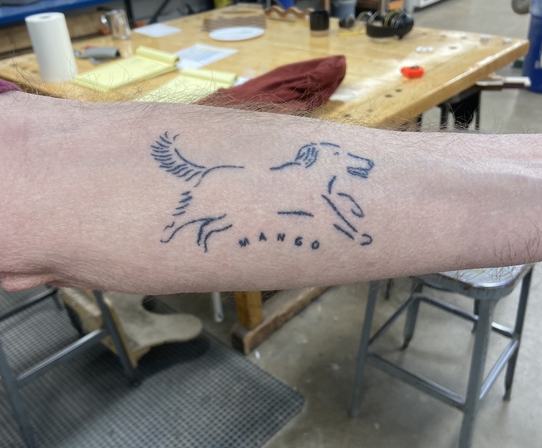 A tattoo of a dog on Pierattini's forearm