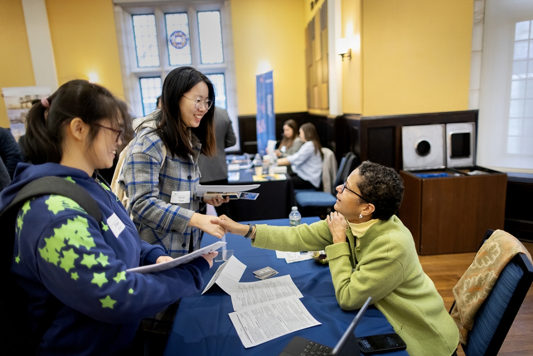 Dominique M. Hawkins greets two students