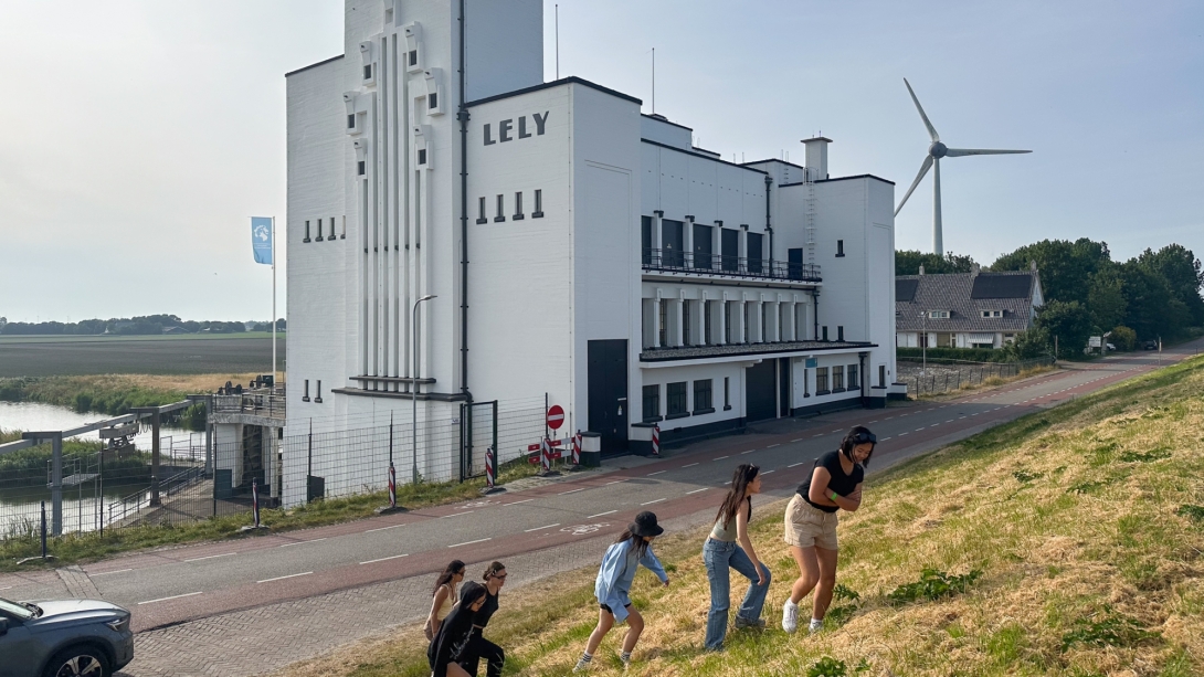 Group of young people climbing hill on sunny day