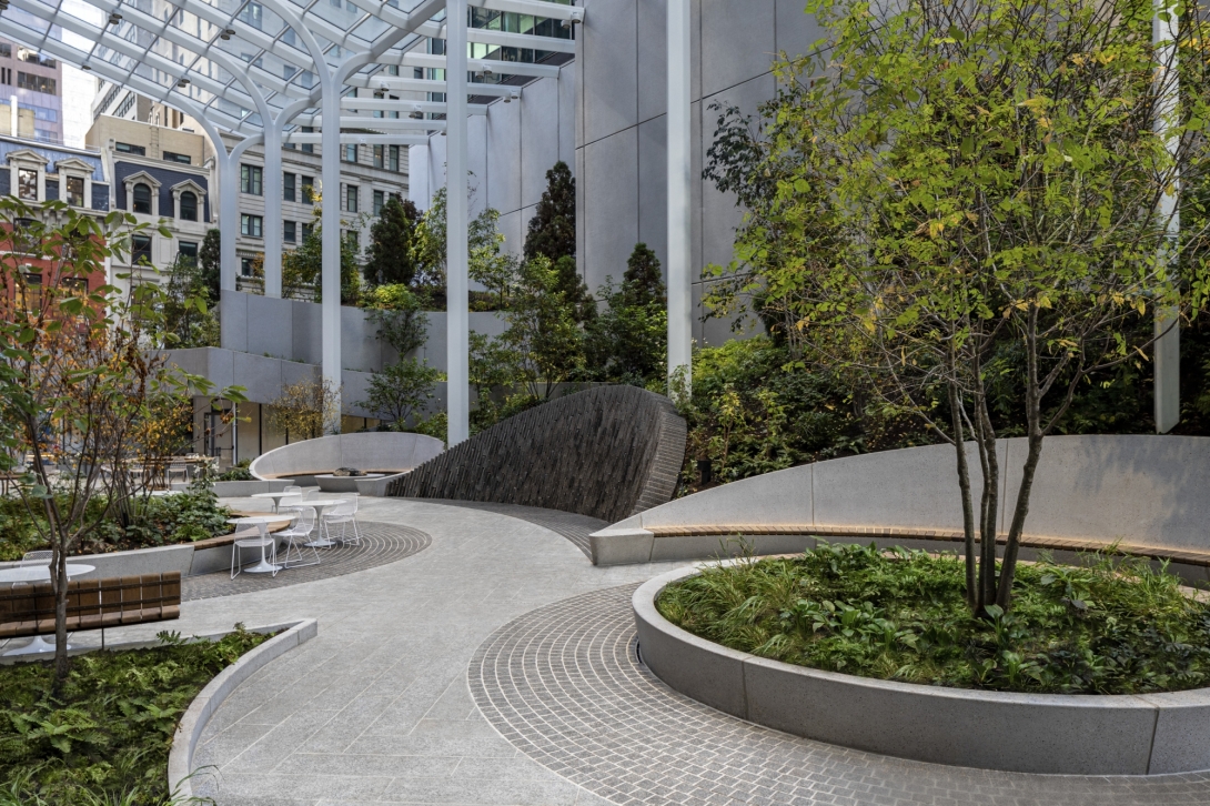 Terraced plantings alongside curving walkway and round planters