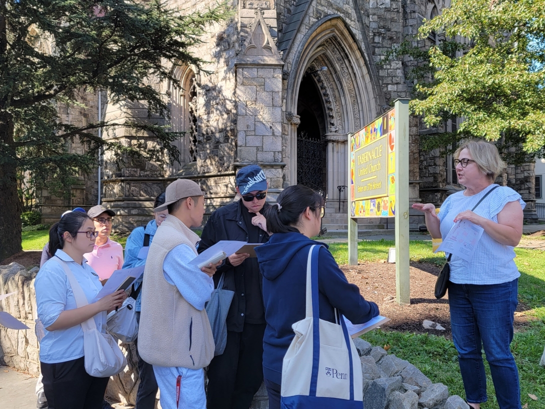 group of people stand in front of church