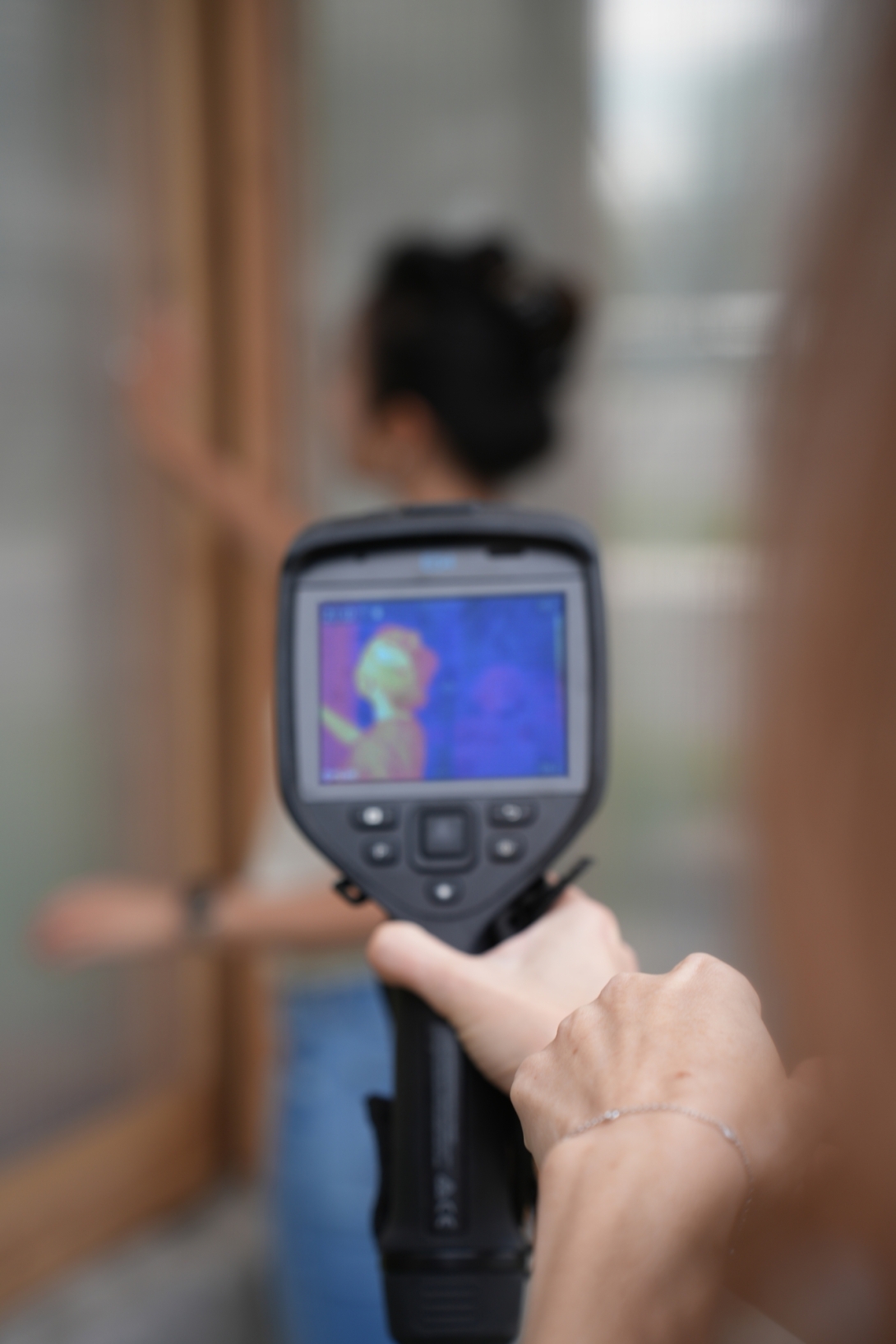 View of person being cooled by panel seen through infrared camera 