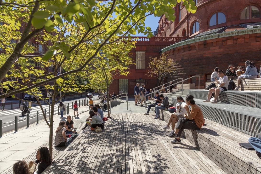 People sitting on the steps of Weitzman Plaza