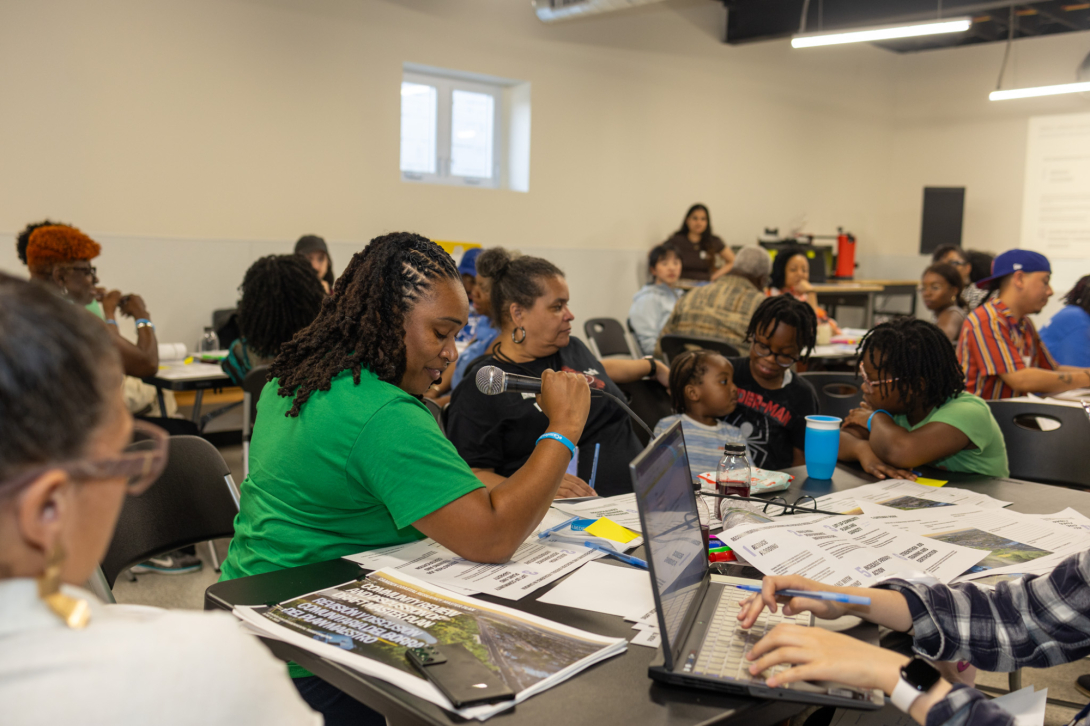 People gathered at round tables in conversation