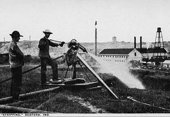 Historic photo of a man power washing a stone