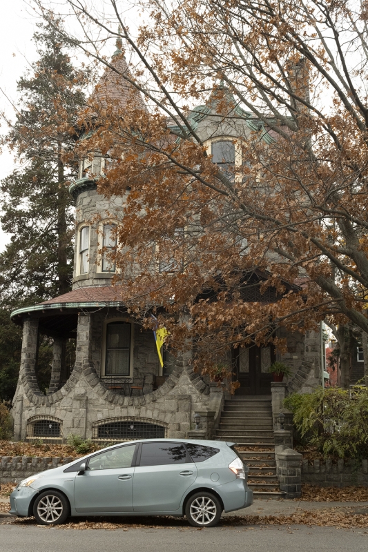 “The Stone House” at 1006 S 46th St, a detached three-story stone masonry Romanesque house.
