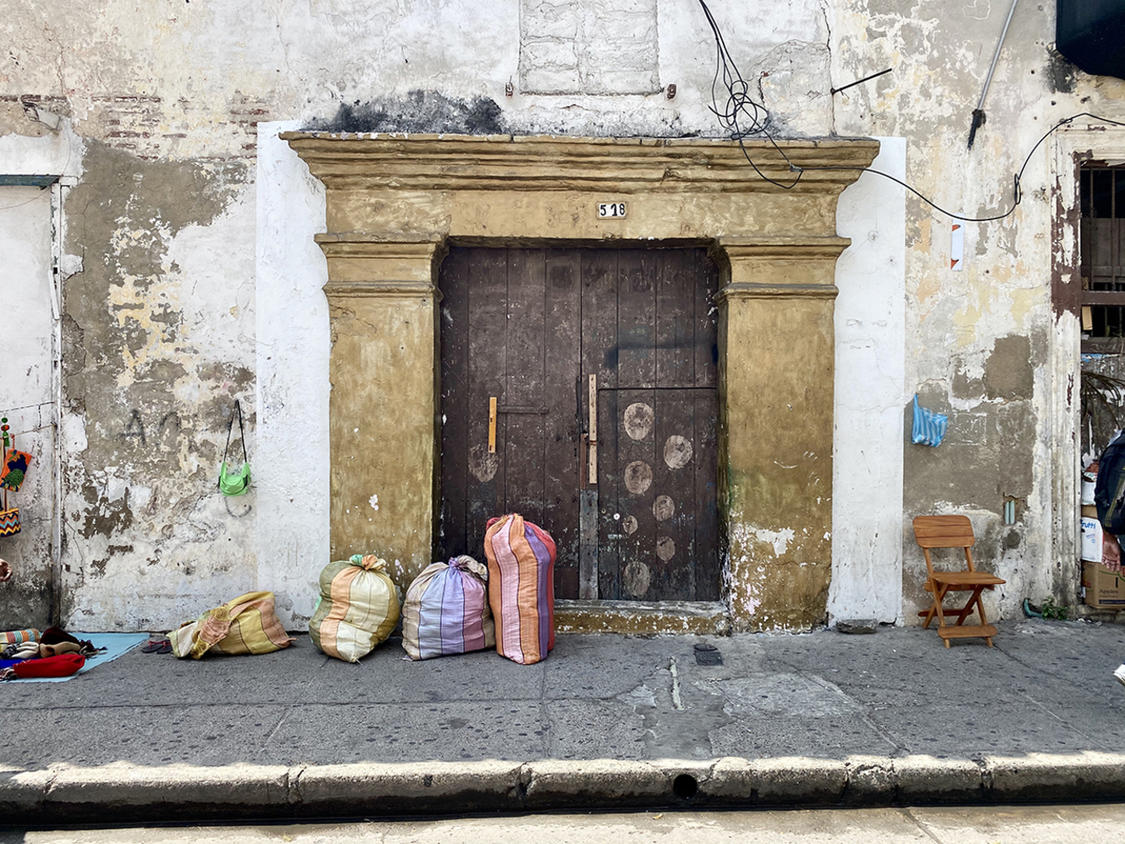 Photo of an old door with packages set on the ground