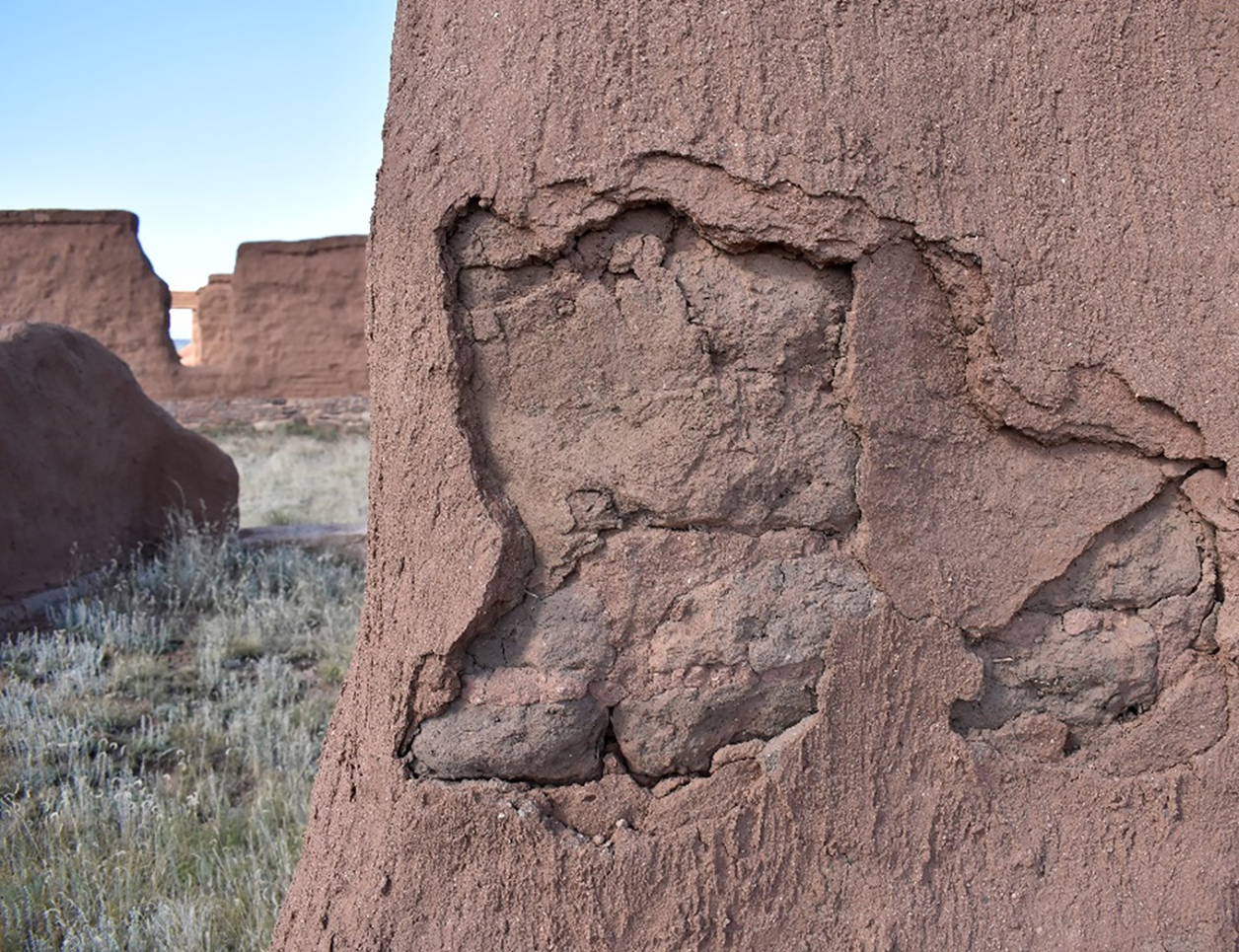 Spalled shelter coat leaving the original adobe exposed to the elements at Fort Union National Monument in September 2021 (Photo