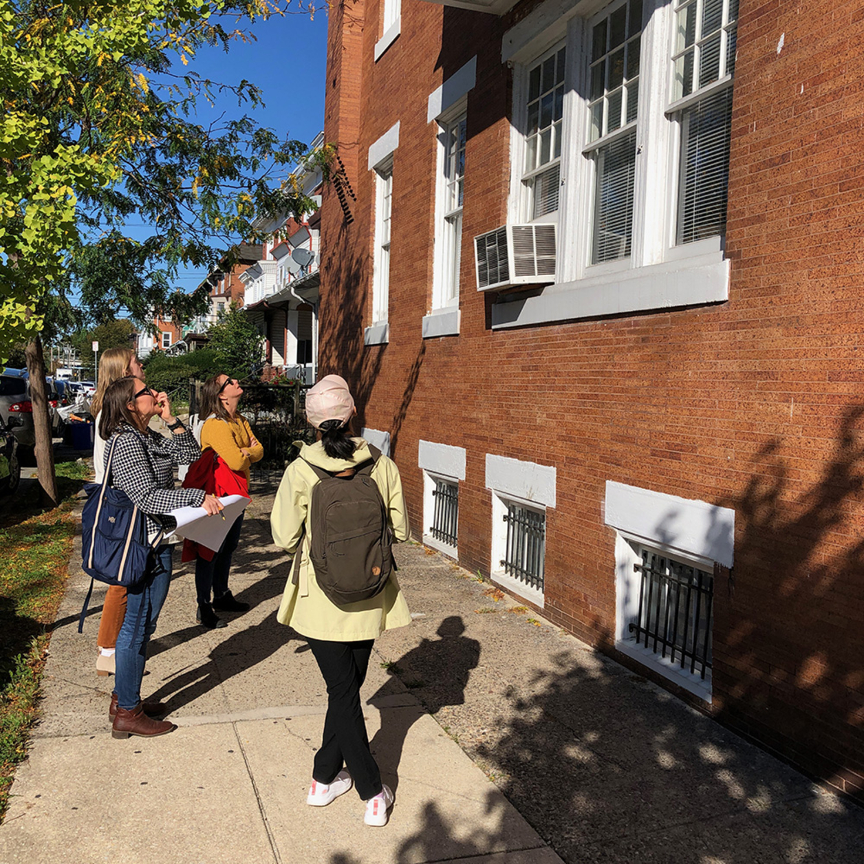 Team members inspecting the western facade of the Robeson House with Mel and Jess. Photo by Pamela W. Hawkes.