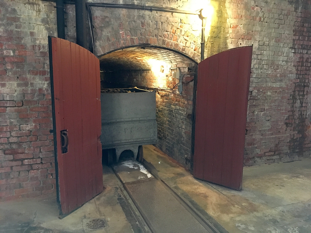 One of the coal carts in the entrance to the tunnel in The Elms’ basement. Photo by author.